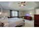 Bedroom with tray ceiling, neutral walls, bedside tables, and a wooden chest of drawers at 1401 Shadow Ct, Zionsville, IN 46077