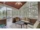Inviting screened-in porch with comfortable seating, wood ceiling and an open view of the backyard, ideal for relaxation at 1401 Shadow Ct, Zionsville, IN 46077