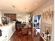 Traditional dining room with hardwood floors, wood table, and view to sunroom at 1407 Aggie Ln, Indianapolis, IN 46260