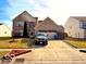 Charming two-story brick home featuring a manicured lawn and attached two-car garage at 1407 Aggie Ln, Indianapolis, IN 46260