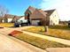 A well-maintained single-Gathering home with a green lawn and an asphalt driveway leading to a two-car garage at 1407 Aggie Ln, Indianapolis, IN 46260