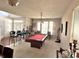 Spacious game room featuring a pool table, barstools, and ample natural light from the windows at 1407 Aggie Ln, Indianapolis, IN 46260