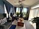 Bright sunroom with large windows, comfortable seating, stylish decor, and an array of healthy potted plants at 1407 Aggie Ln, Indianapolis, IN 46260