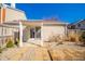 Inviting backyard with a covered patio, brick pavers, and a mix of gravel, and some landscaping at 142 Norbeck Ter, Indianapolis, IN 46217