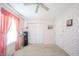 Bedroom showcases a closet with white doors, complementing the pink floral wallpaper for a cozy aesthetic at 142 Norbeck Ter, Indianapolis, IN 46217