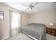 Neutral bedroom offers a window with coverings, ceiling fan, carpet, and a queen size bed perfect for relaxation at 142 Norbeck Ter, Indianapolis, IN 46217