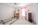 Bedroom displays a window with pink coverings and floral wallpaper, creating a charming and inviting atmosphere at 142 Norbeck Ter, Indianapolis, IN 46217
