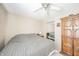 Comfortable bedroom offering ceiling fan, carpet, and closet with mirrored doors, and armoire for storage at 142 Norbeck Ter, Indianapolis, IN 46217