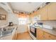 Efficient kitchen featuring warm wood cabinetry, practical appliances, and bright lighting at 142 Norbeck Ter, Indianapolis, IN 46217