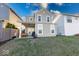 Well-maintained backyard with a covered patio, lush green grass, and a cozy fire pit at 14241 Antiquity Dr, Carmel, IN 46033