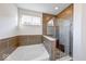 Beautiful bathroom showcasing a glass walk-in shower and separate tub with stylish tile features at 14241 Antiquity Dr, Carmel, IN 46033