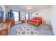 Spacious bedroom with plush carpet, a classic wooden bed, and lots of natural light from large windows at 14241 Antiquity Dr, Carmel, IN 46033