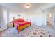 Bright bedroom featuring soft carpet, a wooden bed, and easy access to an en-suite bathroom at 14241 Antiquity Dr, Carmel, IN 46033