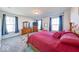 Charming bedroom with cozy carpet, a decorative wooden bed, and plenty of natural light at 14241 Antiquity Dr, Carmel, IN 46033