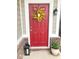 Inviting red front door adorned with a decorative wreath and stylish accents at 14241 Antiquity Dr, Carmel, IN 46033