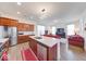 Open kitchen featuring an island, stainless steel appliances, wood cabinets and view to the living room at 14241 Antiquity Dr, Carmel, IN 46033