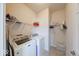 Practical laundry room featuring modern washer and dryer with convenient shelving and storage at 14241 Antiquity Dr, Carmel, IN 46033