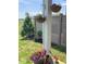 Outdoor living space with hanging flower baskets and landscaped yard at 14241 Antiquity Dr, Carmel, IN 46033