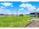 Expansive backyard featuring lush green lawn, mature trees, and a storage shed on a bright day at 1585 S 600 W, New Palestine, IN 46163