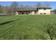 Backyard view of house with brick and siding, featuring a covered patio at 1585 S 600 W, New Palestine, IN 46163