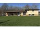 Backyard view of house with brick and siding, featuring a covered patio at 1585 S 600 W, New Palestine, IN 46163