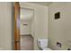 Small bathroom features a toilet with shelves and a doorway into a bedroom at 1585 S 600 W, New Palestine, IN 46163