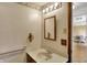 Neutral bathroom featuring a single sink vanity, lighted mirror and convenient accessibility grab bar at 1585 S 600 W, New Palestine, IN 46163