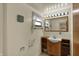 Bright bathroom with a single vanity, lighted mirror, and window for natural light at 1585 S 600 W, New Palestine, IN 46163
