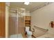 Cozy bathroom features a glass shower, toilet, a shelf, and accessibility features, ideal for comfortable personal care at 1585 S 600 W, New Palestine, IN 46163