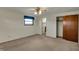 Spacious carpeted bedroom with a ceiling fan, large closet, and access to an ensuite bathroom at 1585 S 600 W, New Palestine, IN 46163