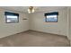 Well-lit bedroom with two windows, neutral walls, and a comfortable carpet flooring at 1585 S 600 W, New Palestine, IN 46163