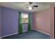 Colorful bedroom with blue carpet, purple and pink walls and a bright green window treatment at 1585 S 600 W, New Palestine, IN 46163