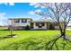 Charming two-story home with a lush green lawn, mature trees, and welcoming front porch on a bright day at 1585 S 600 W, New Palestine, IN 46163