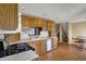 Well-lit kitchen featuring stainless steel appliances, wooden cabinets, and easy access to the adjacent staircase at 1585 S 600 W, New Palestine, IN 46163