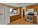 Spacious kitchen with stainless steel oven, wood cabinets, countertops, and natural light offering a delightful cooking space at 1585 S 600 W, New Palestine, IN 46163