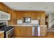 Functional kitchen features wooden cabinets, stainless steel appliances, and a large sink for easy meal prep at 1585 S 600 W, New Palestine, IN 46163
