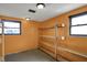 A storage area showcasing wooden shelving, bright walls, and natural light from two windows at 1585 S 600 W, New Palestine, IN 46163