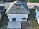 Aerial view of a home with a gray roof, white siding, concrete patio, and green grass at 1809 S H St, Elwood, IN 46036