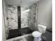Modern bathroom featuring a glass shower with marble tiles and a black herringbone floor at 1809 S H St, Elwood, IN 46036