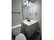 Cozy bathroom with gray vanity, modern fixtures, and a stylish mirror at 1809 S H St, Elwood, IN 46036