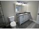 Bathroom featuring a double vanity, granite countertops, and wood-look flooring at 1809 S H St, Elwood, IN 46036