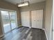 Bedroom with wood floor, two closets and a sliding glass door leading to a patio at 1809 S H St, Elwood, IN 46036