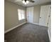Bedroom with gray carpet, white trim, ceiling fan, a window providing natural light, and a closet at 1809 S H St, Elwood, IN 46036