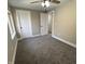 Bedroom with gray carpet, white trim, ceiling fan, a window providing natural light, and two closets at 1809 S H St, Elwood, IN 46036