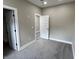 Bedroom with gray carpet and two doors at 1809 S H St, Elwood, IN 46036