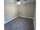 Neutral bedroom features carpeted floors, a ceiling fan with lights, and clean, painted walls at 1809 S H St, Elwood, IN 46036