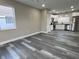 Open-concept living room seamlessly connects to the kitchen, featuring modern flooring and neutral tones at 1809 S H St, Elwood, IN 46036