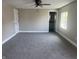 Spacious primary bedroom with neutral carpet, ceiling fan, and a bright window at 1809 S H St, Elwood, IN 46036
