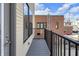 Spacious balcony featuring black metal railings and views of exterior brick building at 1842 Central Ave, Indianapolis, IN 46202