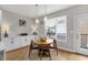 Bright dining area with a round table, modern lighting, and a door to the balcony at 1842 Central Ave, Indianapolis, IN 46202